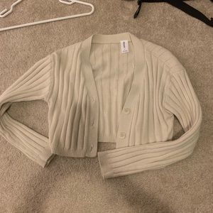 Beige cropped cardigan sweater rubbed with buttons